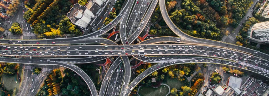 An aerial view of two interstates intersecting with many cars